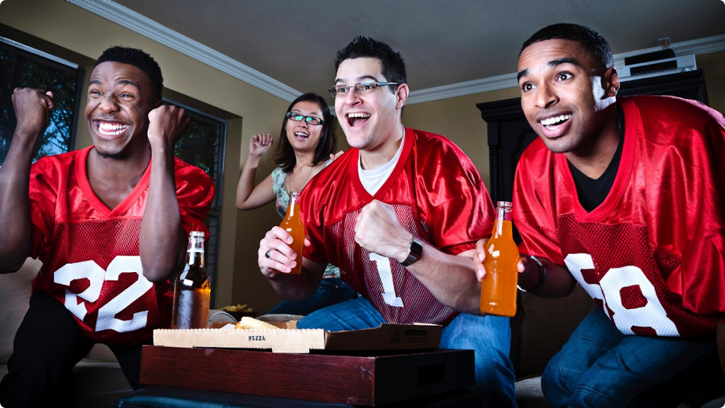 SB090613-sports-fantasy-football-fans-watching-game-tv-team-men-happy - Banister Nutrition, LLC | OKC Dietitian | Nutrition